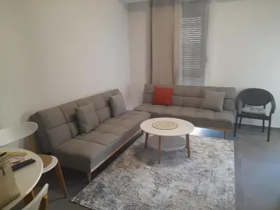 a living room with a couch and a table at Tina city apartment in Ulcinj