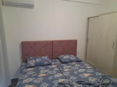 a bed with two pillows on it in a room at Tina city apartment in Ulcinj