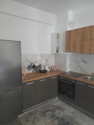a kitchen with grey cabinets and a sink at Tina city apartment in Ulcinj
