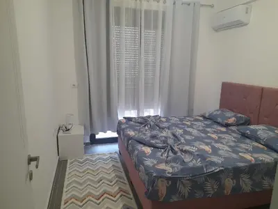 a bedroom with a bed and a window at Tina city apartment in Ulcinj