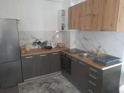 a small kitchen with a sink and a refrigerator at Tina city apartment in Ulcinj