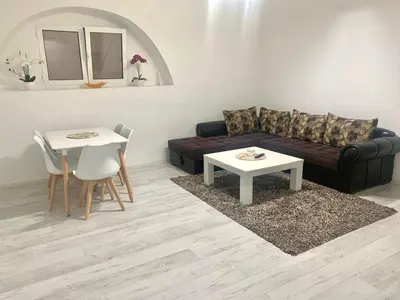 a living room with a couch and a table at Centrum Apartman & Rooms in Ulcinj