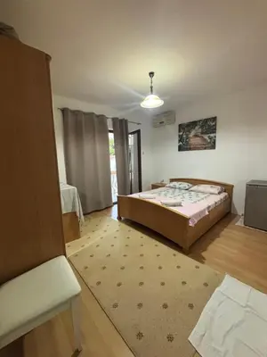 a bedroom with a bed and a room with a window at Centrum Apartman & Rooms in Ulcinj