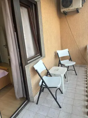 two chairs and a table on a balcony at Centrum Apartman & Rooms in Ulcinj