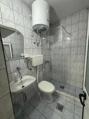 a bathroom with a toilet and a sink at Centrum Apartman & Rooms in Ulcinj