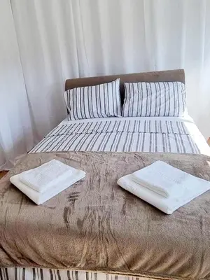 a bed with two white towels on top of it at Studio Apartment Iva in Budva