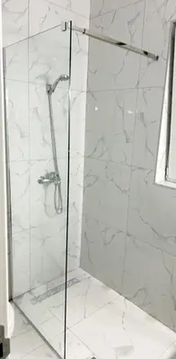 a bathroom with a shower with white marble walls at Studio Apartment Iva in Budva