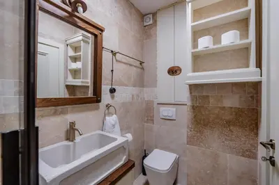 a bathroom with a sink and a toilet and a mirror at Casa Di Mino Old Town in Budva
