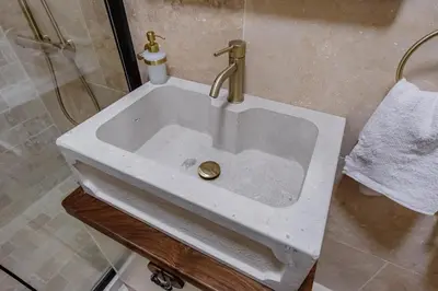 a white sink with a gold faucet in a bathroom at Casa Di Mino Old Town in Budva