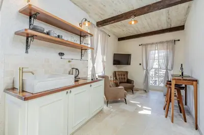 a kitchen with a sink and a living room at Casa Di Mino Old Town in Budva