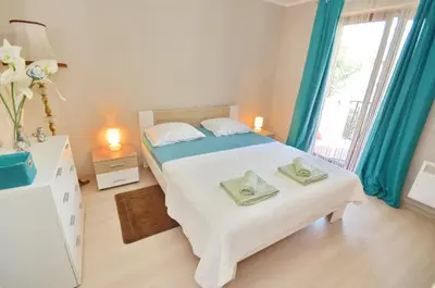 a bedroom with a bed with two towels on it at Apartments Dada in Kotor