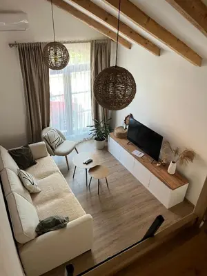 a living room with a couch and a tv at Guest house TAK in Cetinje