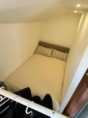 a bed in the corner of a room at Guest house TAK in Cetinje
