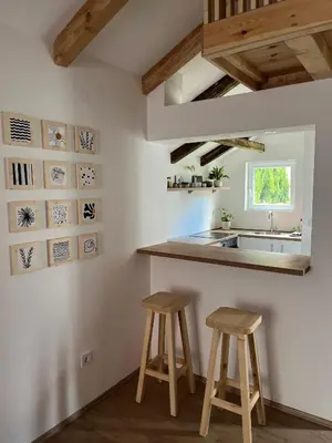 a kitchen with two stools and a counter and a sink at Guest house TAK in Cetinje