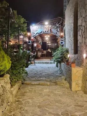 a stone walkway leading to a building at night at Ulcinj - Stonehouse in Oldtown with sea view in Ulcinj