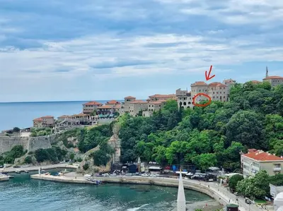 a town on top of a hill next to the water at Ulcinj - Stonehouse in Oldtown with sea view in Ulcinj