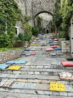 a group of pillows on the steps of a building at Ulcinj - Stonehouse in Oldtown with sea view in Ulcinj