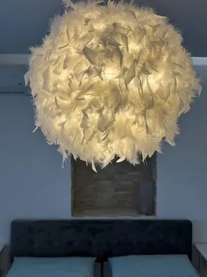 a large chandelier hanging from the ceiling over a bench at Ulcinj - Stonehouse in Oldtown with sea view in Ulcinj