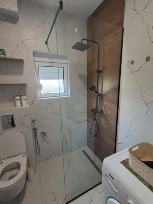 a bathroom with a shower and a toilet at HOME POINT Apartment in Podgorica