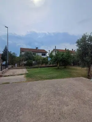 an empty street with a house in the background at HOME POINT Apartment in Podgorica