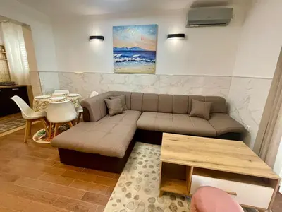 a living room with a couch and a table at Apartment Rafailovici in Rafailovici