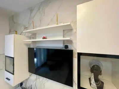 a living room with a black and white marble wall at Apartment Rafailovici in Rafailovici