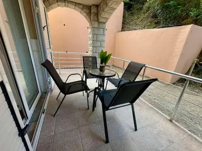 a balcony with a table and chairs on a patio at Apartment Rafailovici in Rafailovici