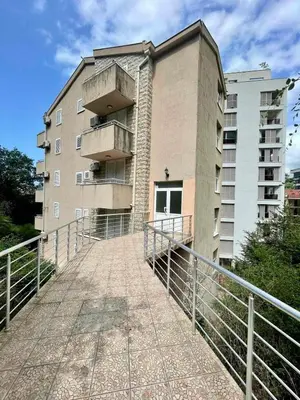 a building with a walkway in front of a building at Apartment Rafailovici in Rafailovici