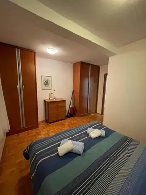 a bedroom with a bed with two towels on it at Bela Vista in Budva