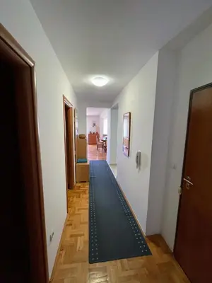 a hallway with a black rug on the floor at Bela Vista in Budva