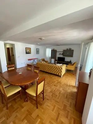 a living room with a table and a couch at Bela Vista in Budva