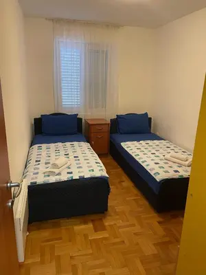 a bedroom with two beds and a window at Bela Vista in Budva