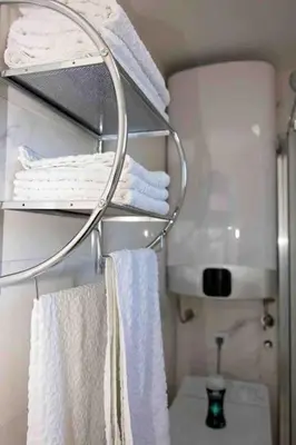 a bathroom with white towels on a rack at Sea view dobra voda in Dobra Voda