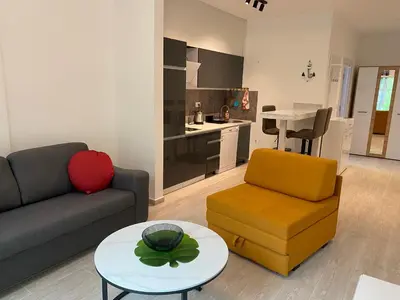 a living room with a couch and a table at VLSB Bečići in Becici
