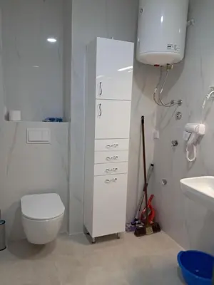 a white bathroom with a toilet and a sink at VLSB Bečići in Becici
