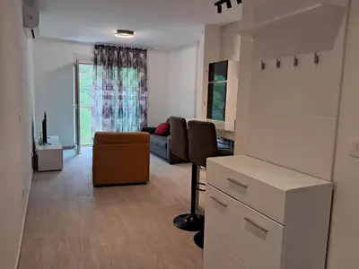 a living room with a couch and a table at VLSB Bečići in Becici