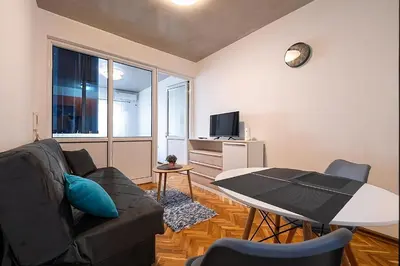 a living room with a couch and a table at Podgorica City Center in Podgorica