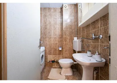 a bathroom with a toilet and a sink at Podgorica City Center in Podgorica