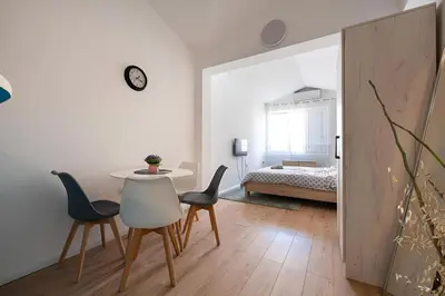 a room with a table and chairs and a bed at Podgorica City Center in Podgorica