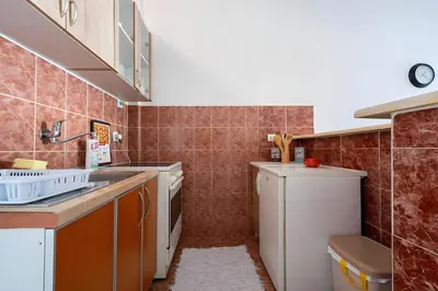 a small kitchen with a sink and a dishwasher at Podgorica City Center in Podgorica