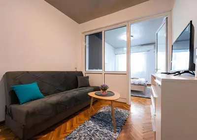 a living room with a couch and a table at Podgorica City Center in Podgorica