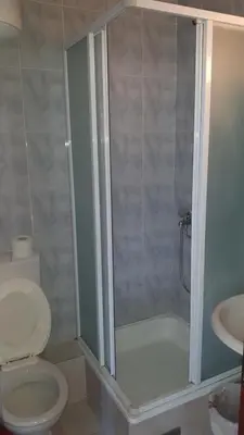 a bathroom with a shower with a toilet and a sink at Guest House Andrea in Budva