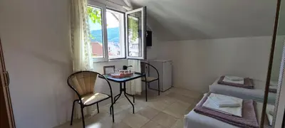 a small room with a table and a window at Guest House Andrea in Budva