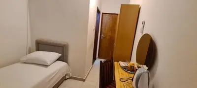 a small bedroom with a bed and a mirror at Guest House Andrea in Budva