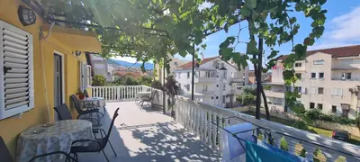 a balcony with a table and chairs and a view at Guest House Andrea in Budva