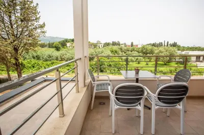 a balcony with a table and chairs and a view at Apartments NIKOS FAMILY in Ulcinj
