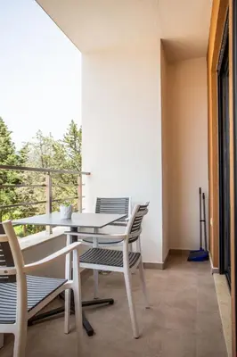 a patio with a table and chairs on a balcony at Apartments NIKOS FAMILY in Ulcinj