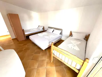 a room with two beds and a window at ADO Apartmani Ulcinj Velika Plaza Donji Stoj in Donji Štoj