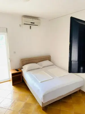 a white bed in a room with a window at ADO Apartmani Ulcinj Velika Plaza Donji Stoj in Donji Štoj