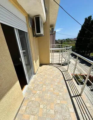 a balcony of a building with a door and a railing at ADO Apartmani Ulcinj Velika Plaza Donji Stoj in Donji Štoj